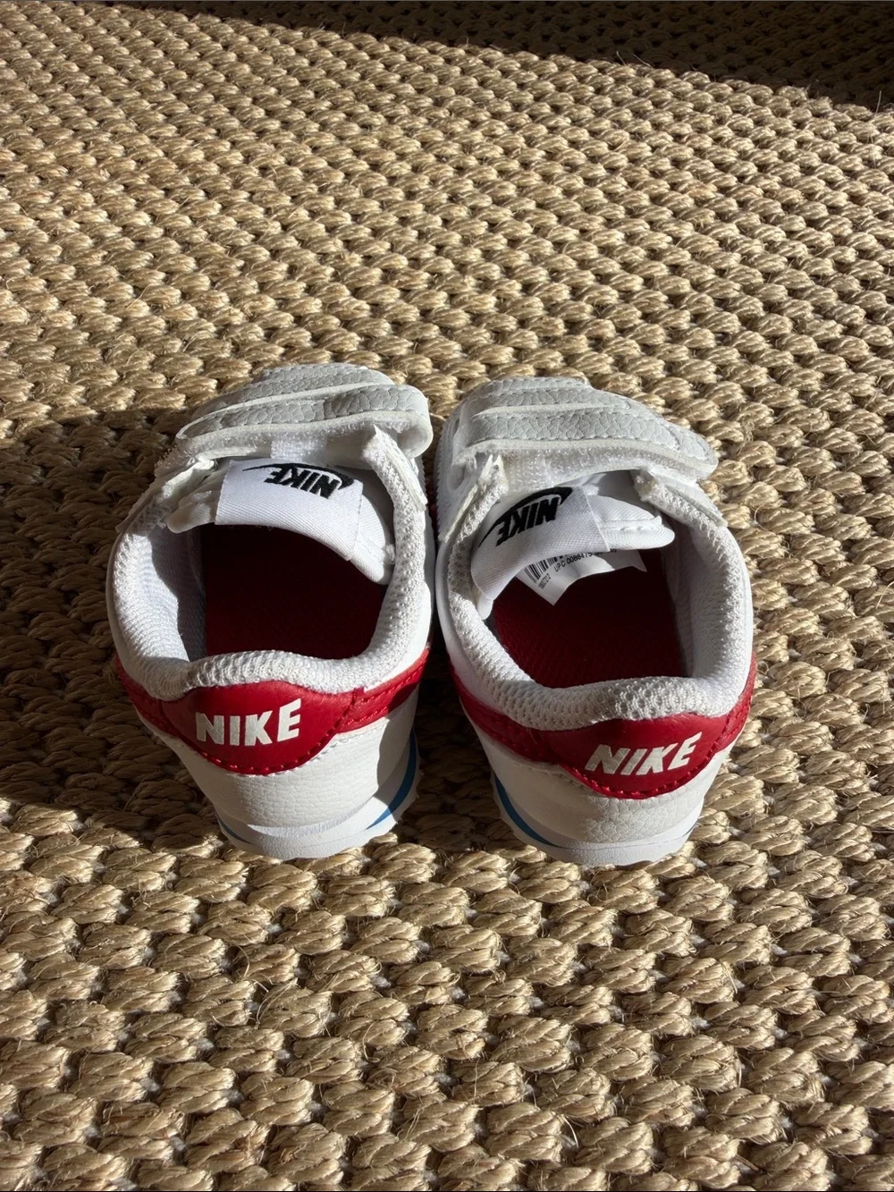 Nike White Baby Sneakers with Red Swoosh and Blue Accent size 4c